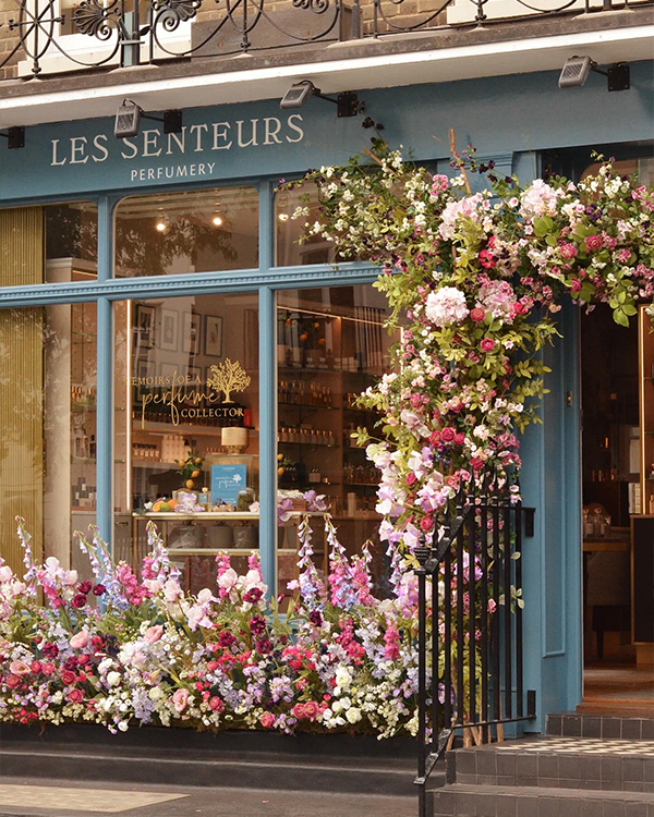 Beautiful London shop front with flower doorway arch and floral display