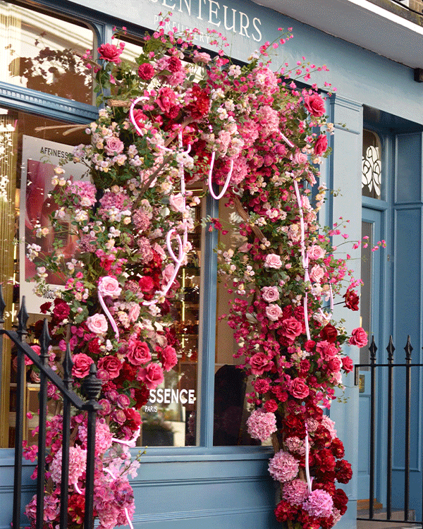 London shop front with flower doorway arch and floral display
