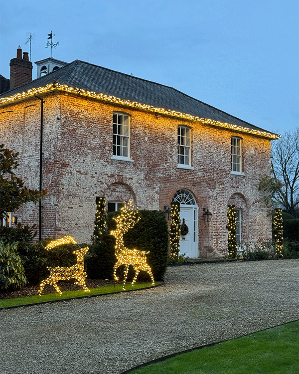 Exterior lighting on house in Hertfordshire with reindeer christmas decorations in front garden
