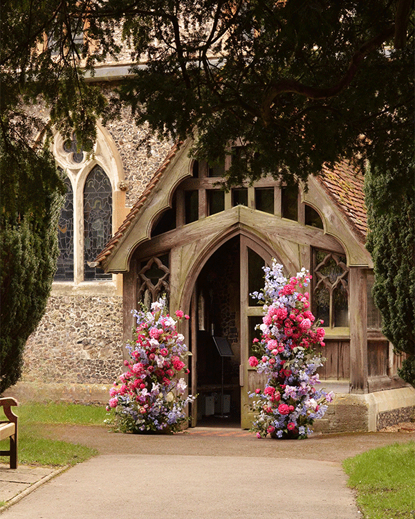 Floral display wedding at church exterior in Surrey